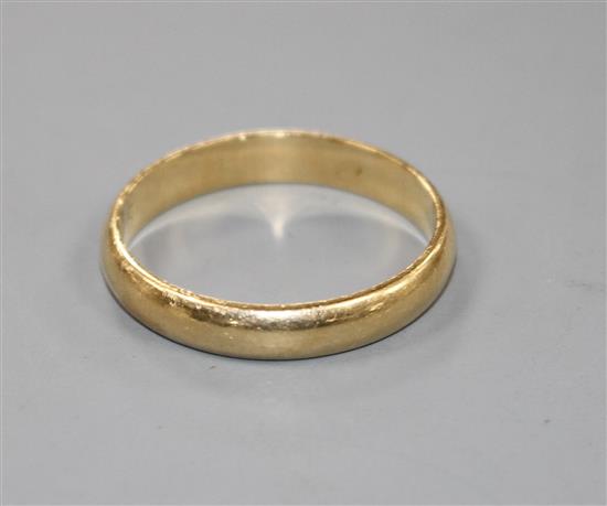 An unmarked yellow metal wedding band, size Y.